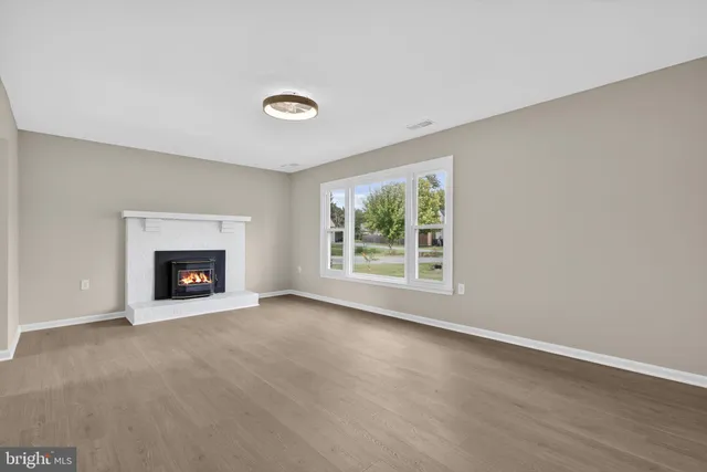a living room with a fireplace and a floor to ceiling window