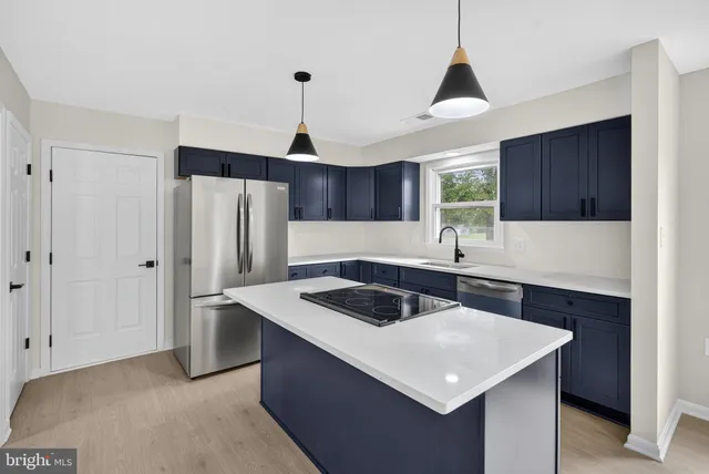 a kitchen with a sink and wooden cabinets