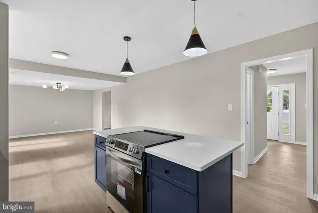 a kitchen with a stove a sink and a refrigerator