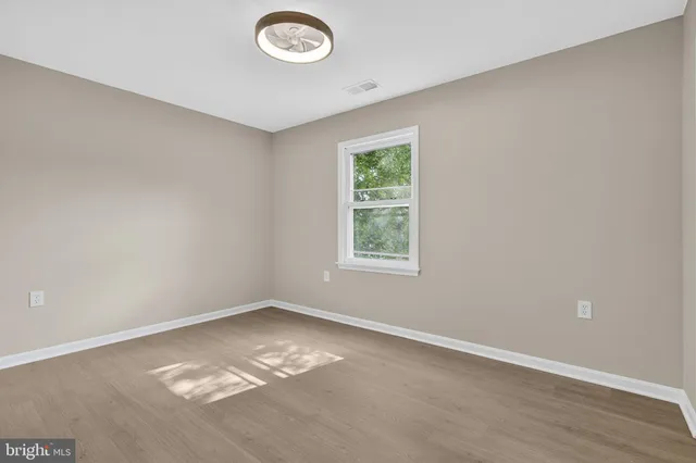 an empty room with wooden floor
