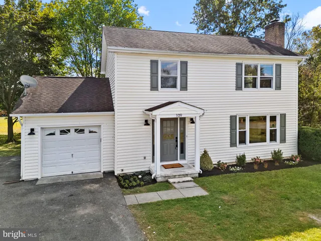 a view of an empty room with a window and fireplace