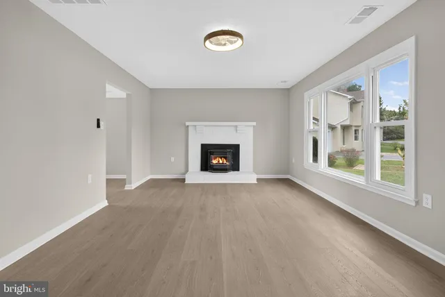 a view of an empty room with a fireplace