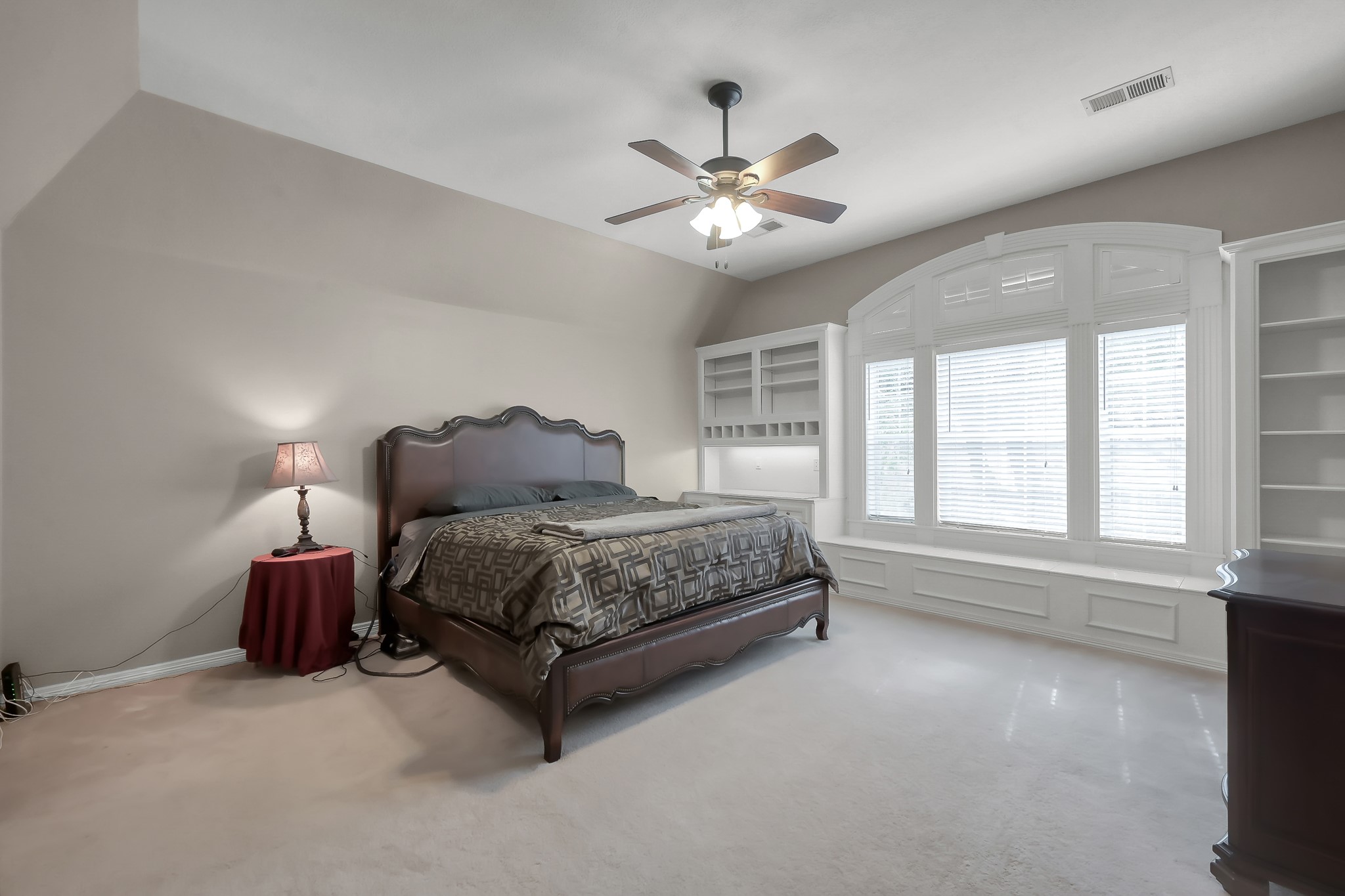 16403 Agusta Court Spring, TX 77379 - Photo 20 of 36 a bedroom with a large bed and a chandelier