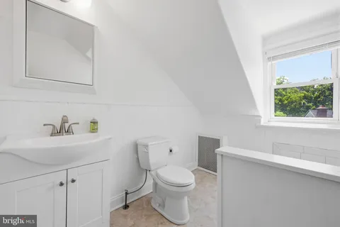 a white toilet sitting next to a bathroom sink