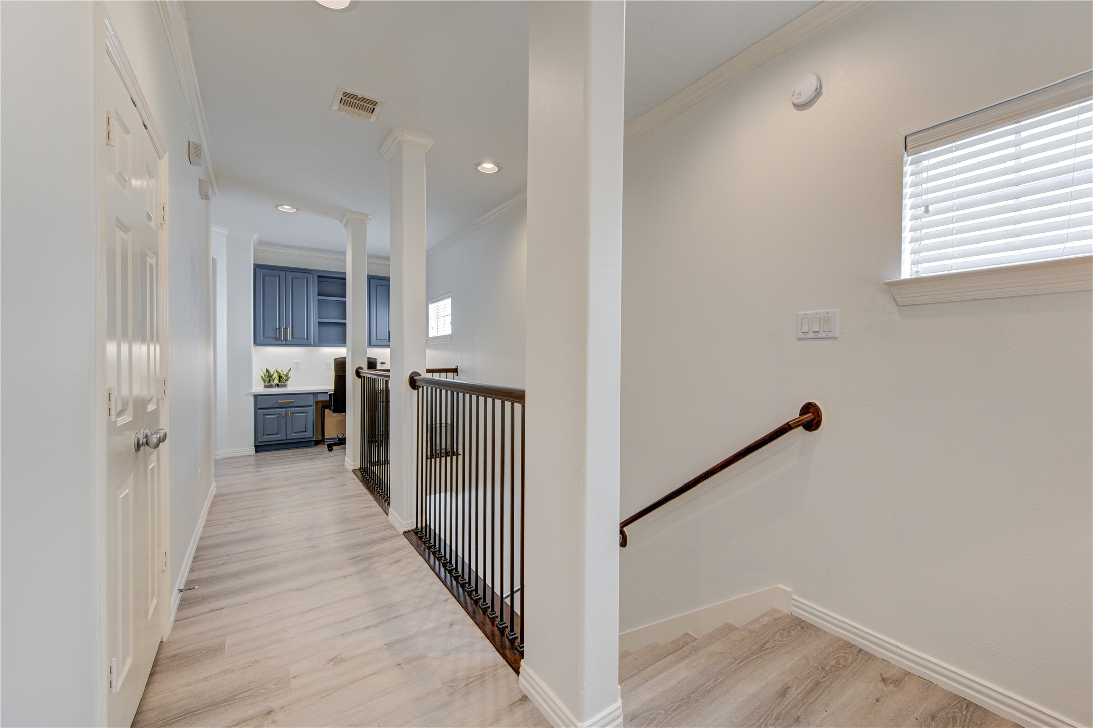 1131 Sopris Drive Houston, TX 77077 - Photo 16 of 35 a view of a hallway with wooden floor and staircase