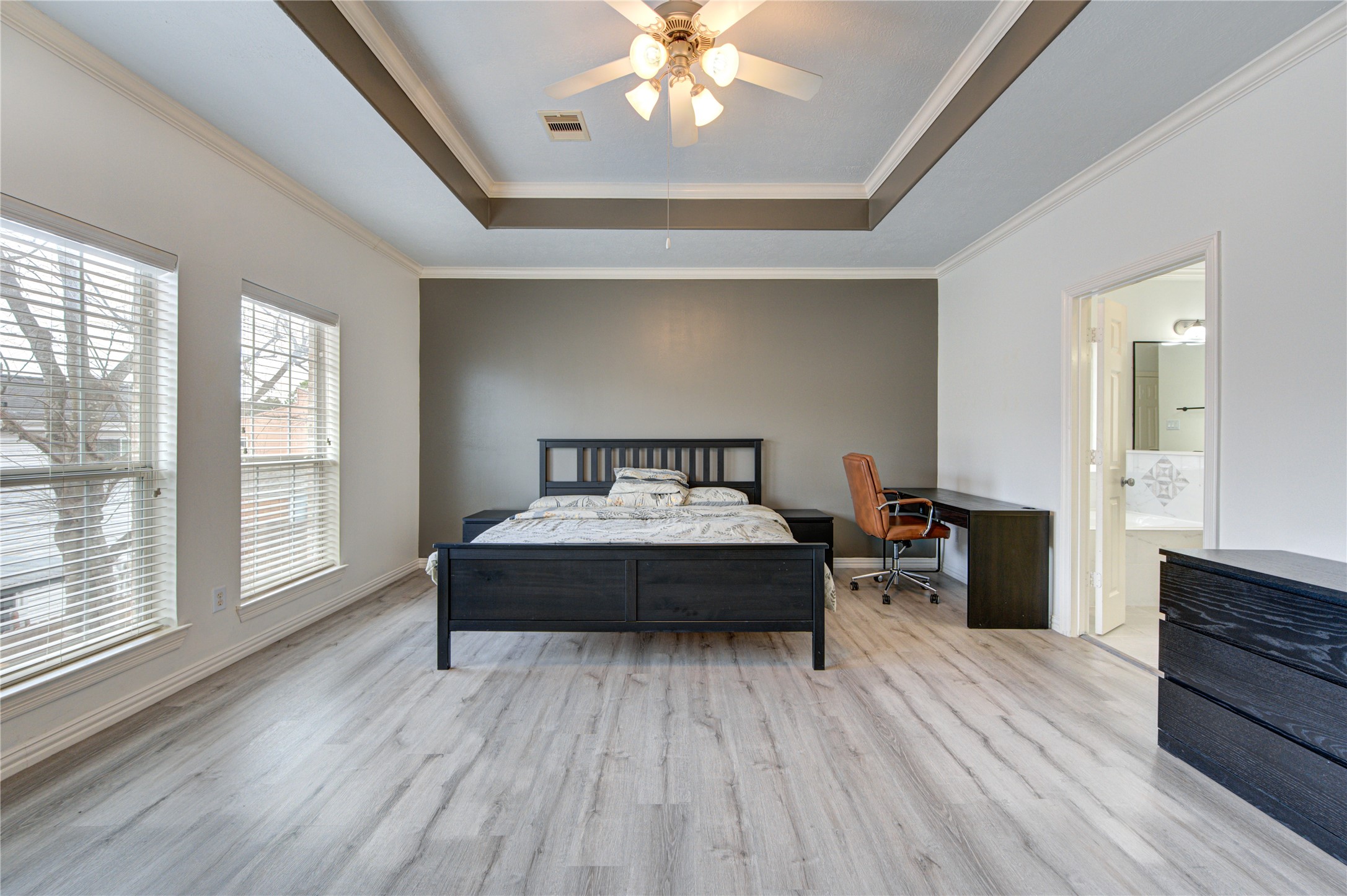 1131 Sopris Drive Houston, TX 77077 - Photo 19 of 35 a spacious bedroom with a bed and a chandelier
