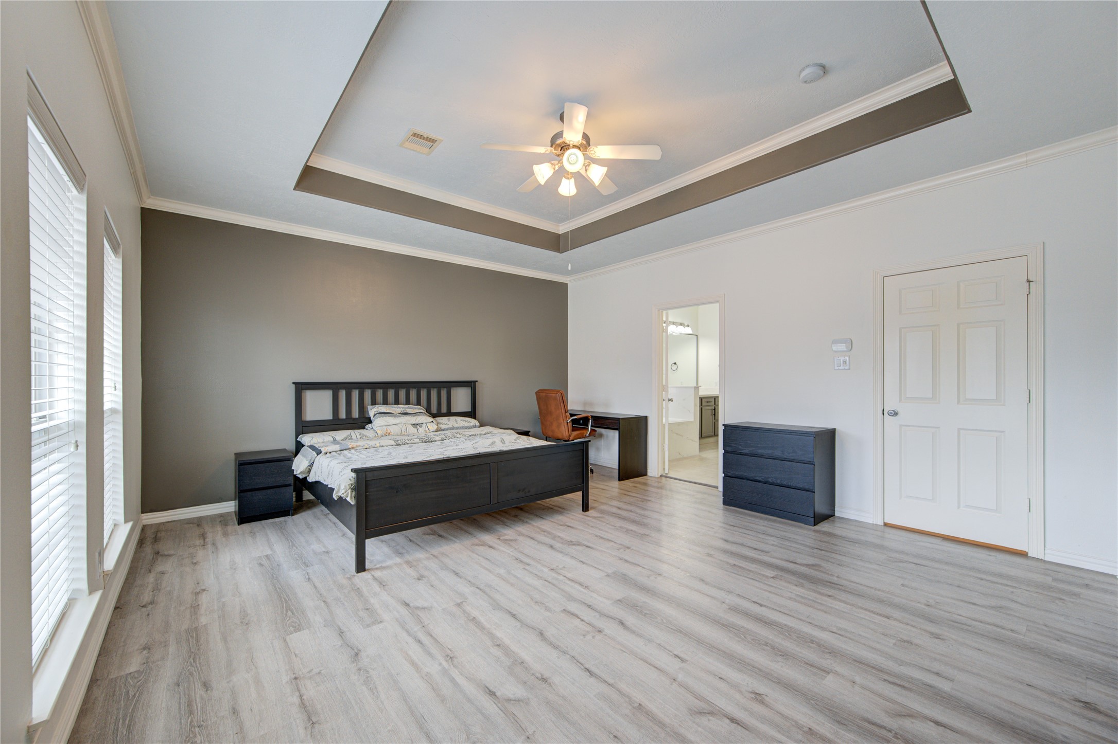 1131 Sopris Drive Houston, TX 77077 - Photo 20 of 35 a spacious bedroom with a bed and a chandelier