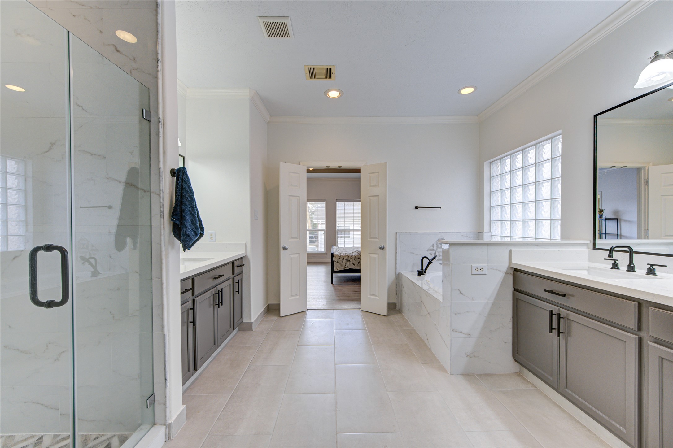 1131 Sopris Drive Houston, TX 77077 - Photo 22 of 35 a bathroom with a double vanity sink a mirror and shower