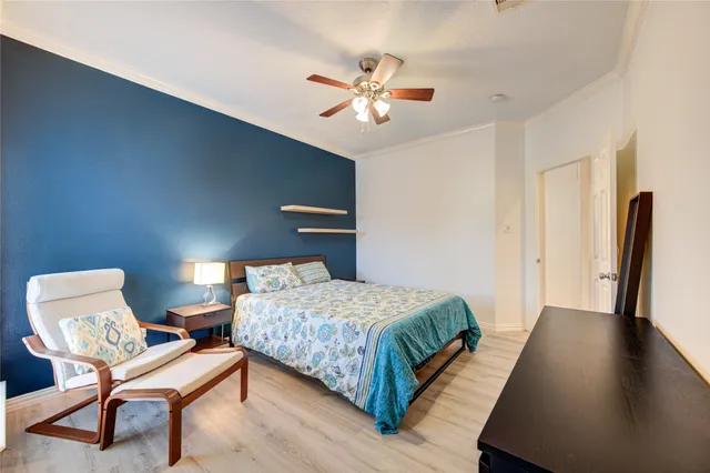 a bedroom with a bed and a chair