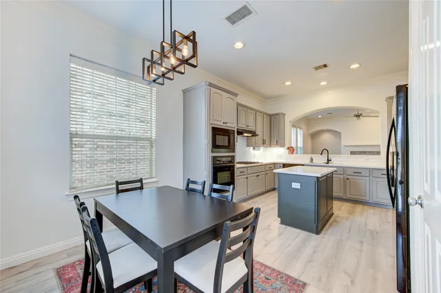 a kitchen with a table and chairs in it