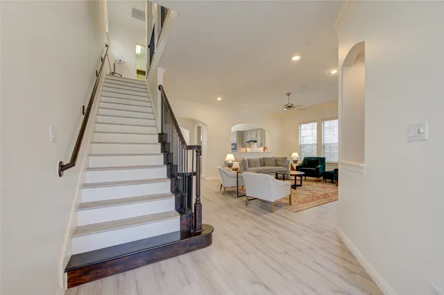 a view of a livingroom with furniture and stairs
