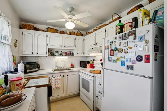 a kitchen with stainless steel appliances a white cabinets and a sink