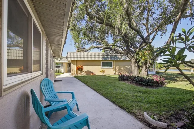 a view of house with backyard and outdoor seating