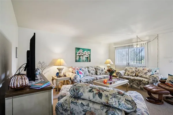 a view of a dining room with furniture and chandelier