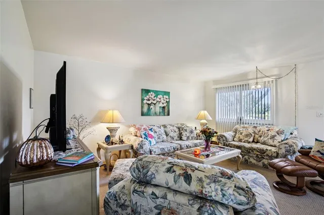 a view of a dining room with furniture and chandelier