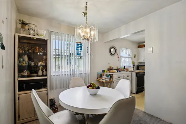 a kitchen with stainless steel appliances a white cabinets and wooden floor