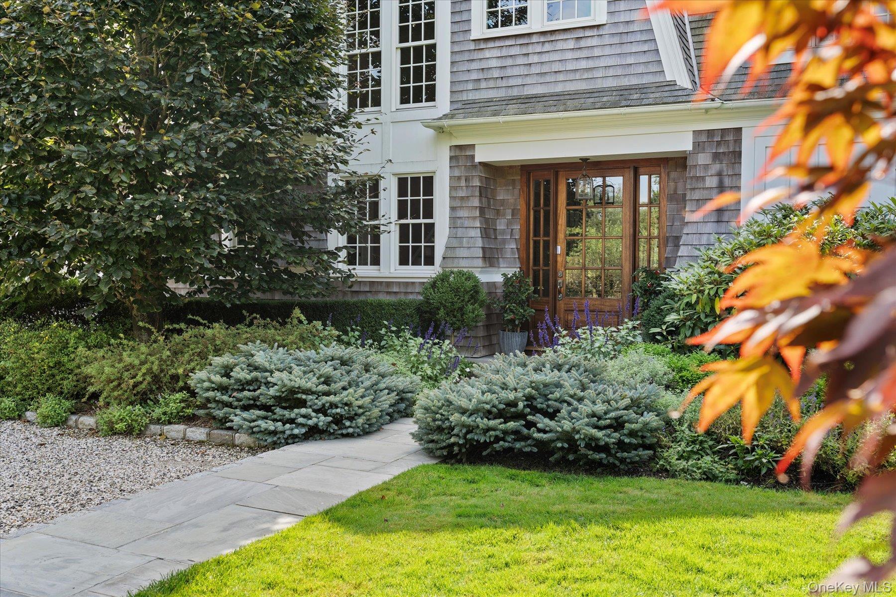 231 Flying Point Road Southampton, NY 11968 - Photo 3 of 34 a view of a house with potted plants and a fountain