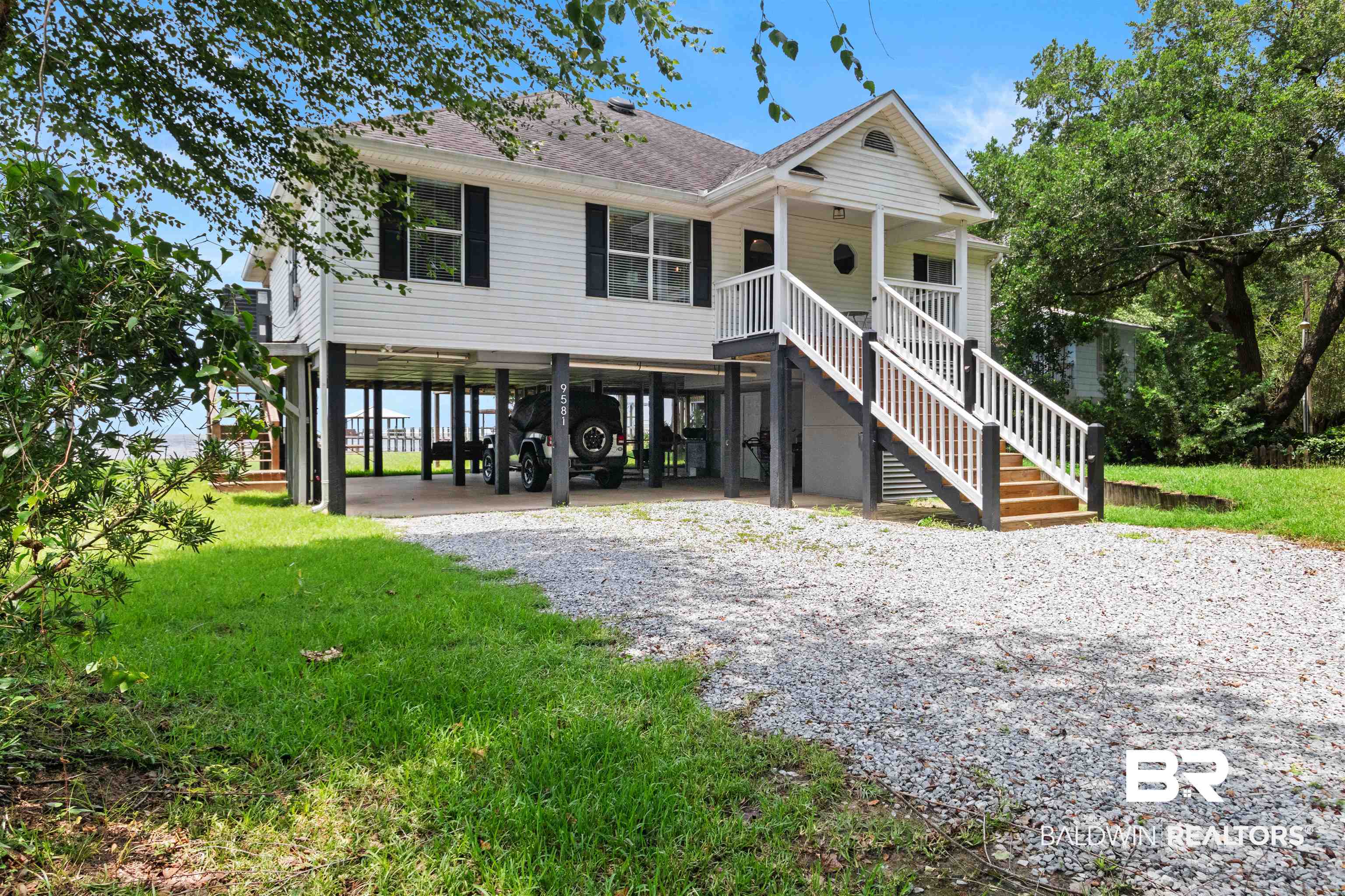 9581 South Bay Street Foley, AL 36535 - Photo 5 of 44 Raised coastal-style home featuring white siding and black window shutters