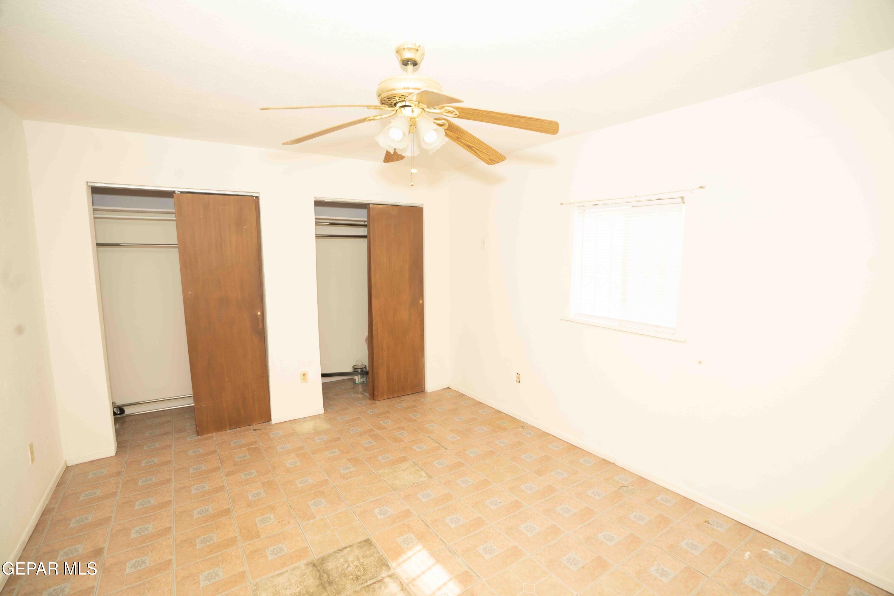 140 Teakwood Road El Paso, TX 79915 - Photo 12 of 16 a view of a room with a ceiling fan and a window