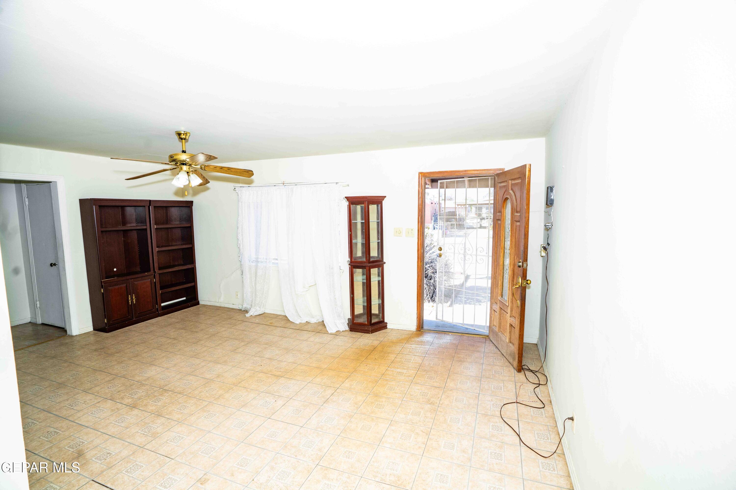 140 Teakwood Road El Paso, TX 79915 - Photo 4 of 16 a view of a livingroom with a chandelier fan and kitchen space