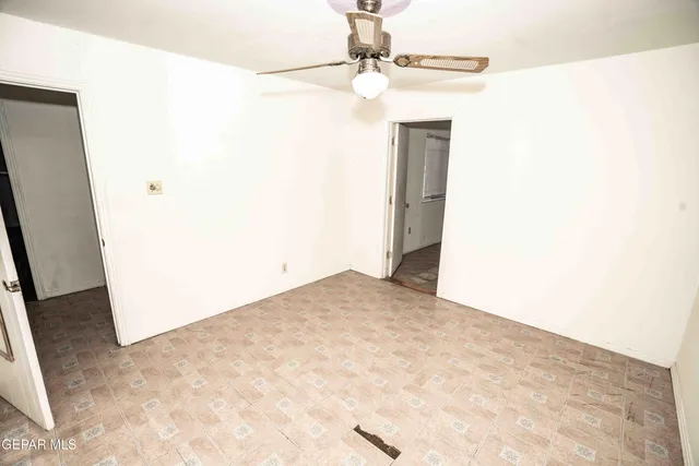 a view of a big room with closet and a chandelier fan