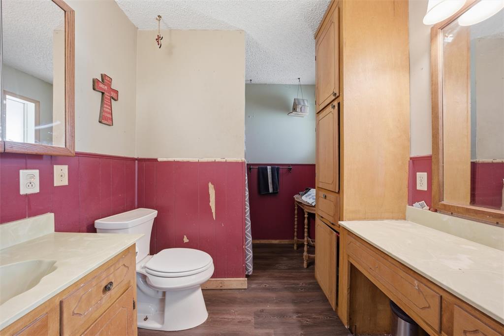 3122 Gun Club Road Temple, TX 76501 - Photo 11 of 22 a bathroom with a granite countertop toilet sink and a mirror