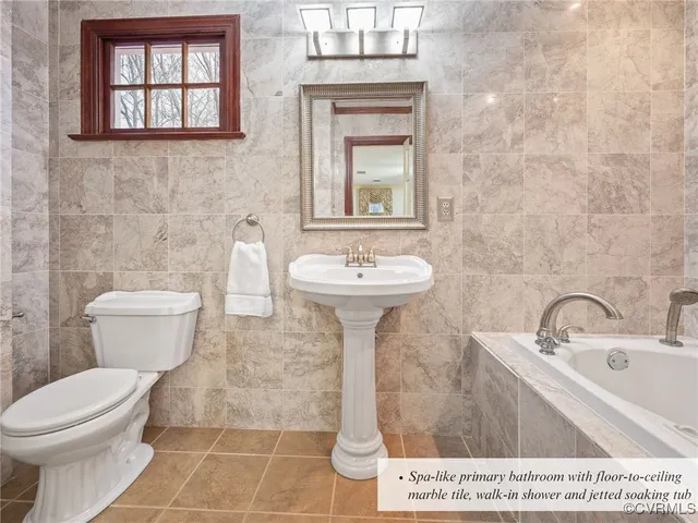 a bed sitting in a bedroom and a chandelier