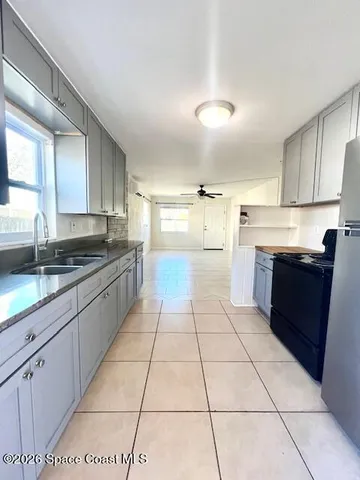 a large kitchen with a stove a sink dishwasher and a refrigerator