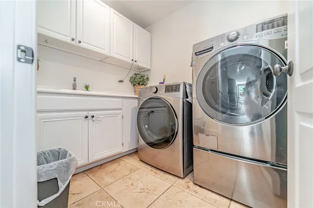 a utility room with sink dryer and washer