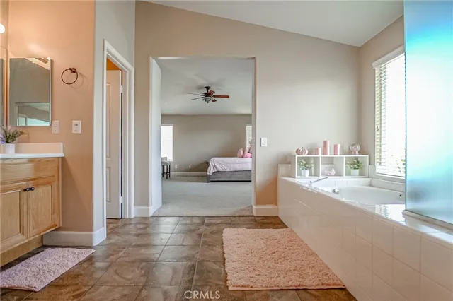 a bathroom with a tub sink and a mirror