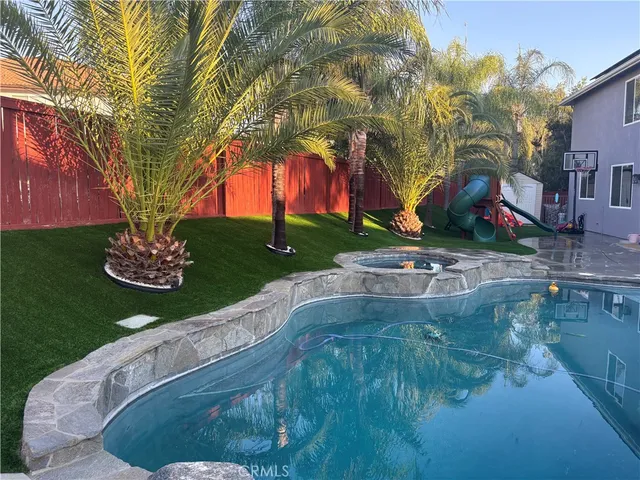 a swimming pool with outdoor seating and yard
