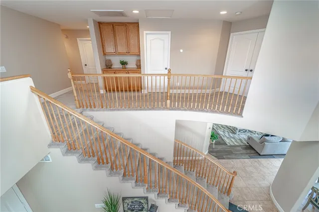 a view of a hallway with wooden floor and windows
