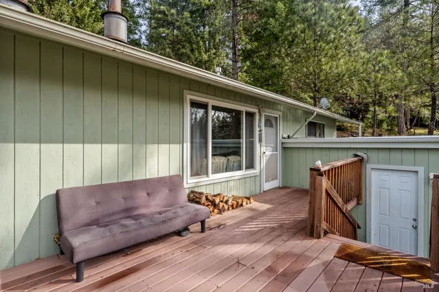 a balcony with furniture and wooden floor