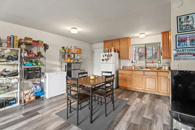 a view of a dining room with furniture and a kitchen