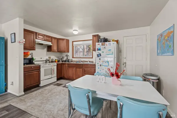 a kitchen with stainless steel appliances kitchen island granite countertop a sink dishwasher and cabinets