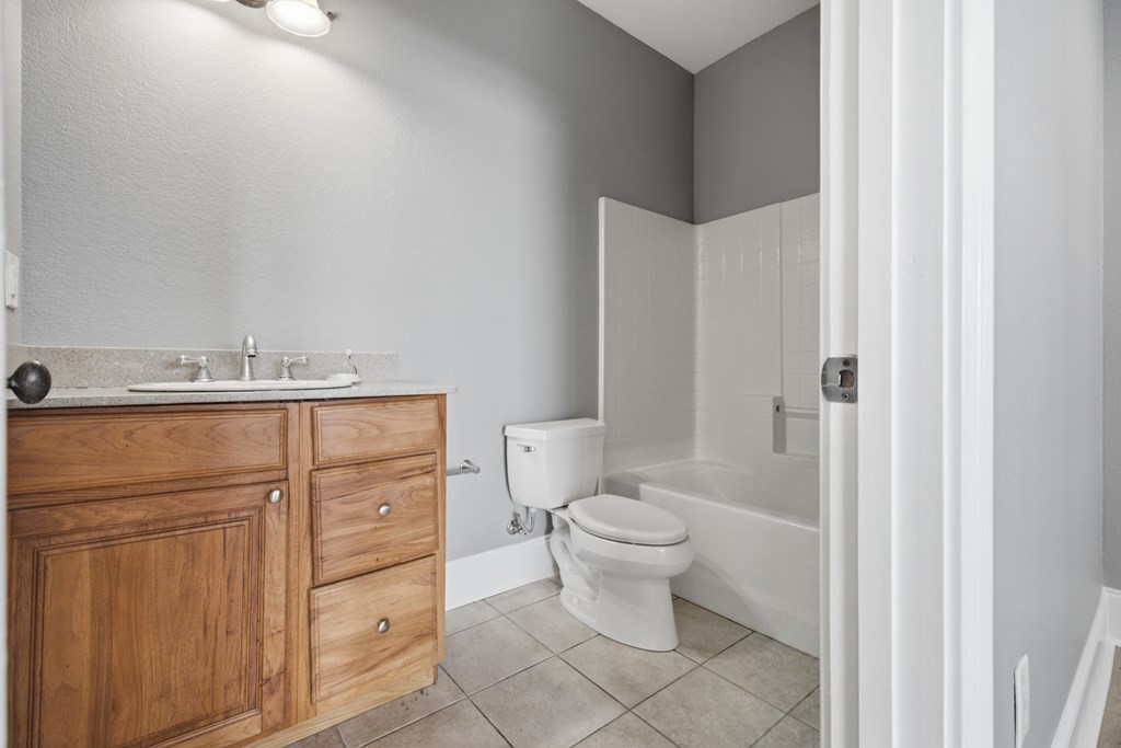 2143 Ridgecrest Circle, Unit 1 Hiawassee, GA 30546 - Photo 22 of 53 a bathroom with a granite countertop toilet sink and mirror
