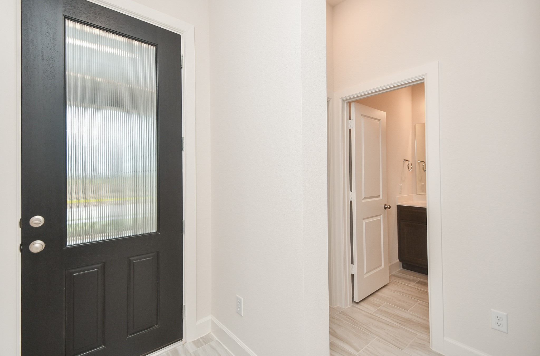 146 Amaranth Way Richmond, TX 77406 - Photo 2 of 18 a view of a bathroom from a hallway