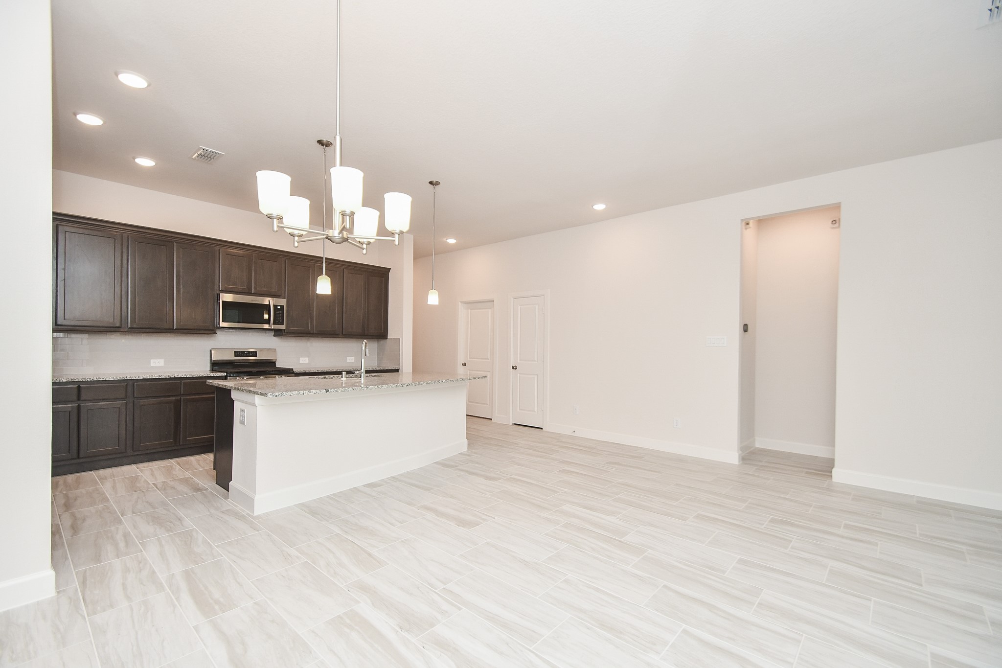 146 Amaranth Way Richmond, TX 77406 - Photo 7 of 18 a large kitchen with a large counter top appliances and cabinets