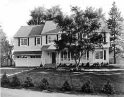 a front view of a residential apartment building with a yard