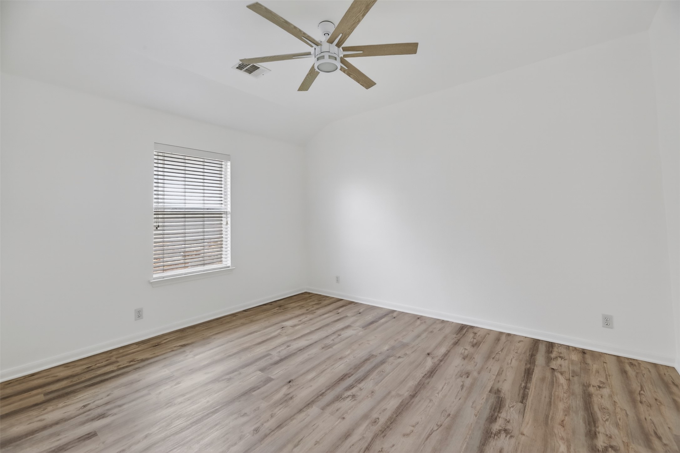 545 Manchester Lane Austin, TX 78737 - Photo 24 of 30 wooden floor in an empty room with a window