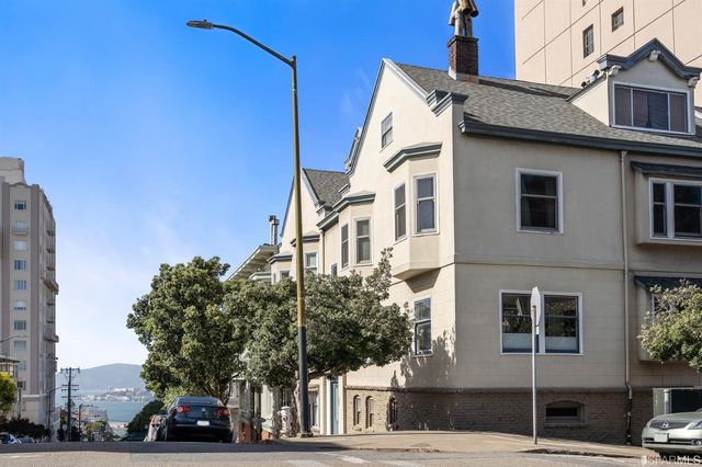 a car parked in front of a white building