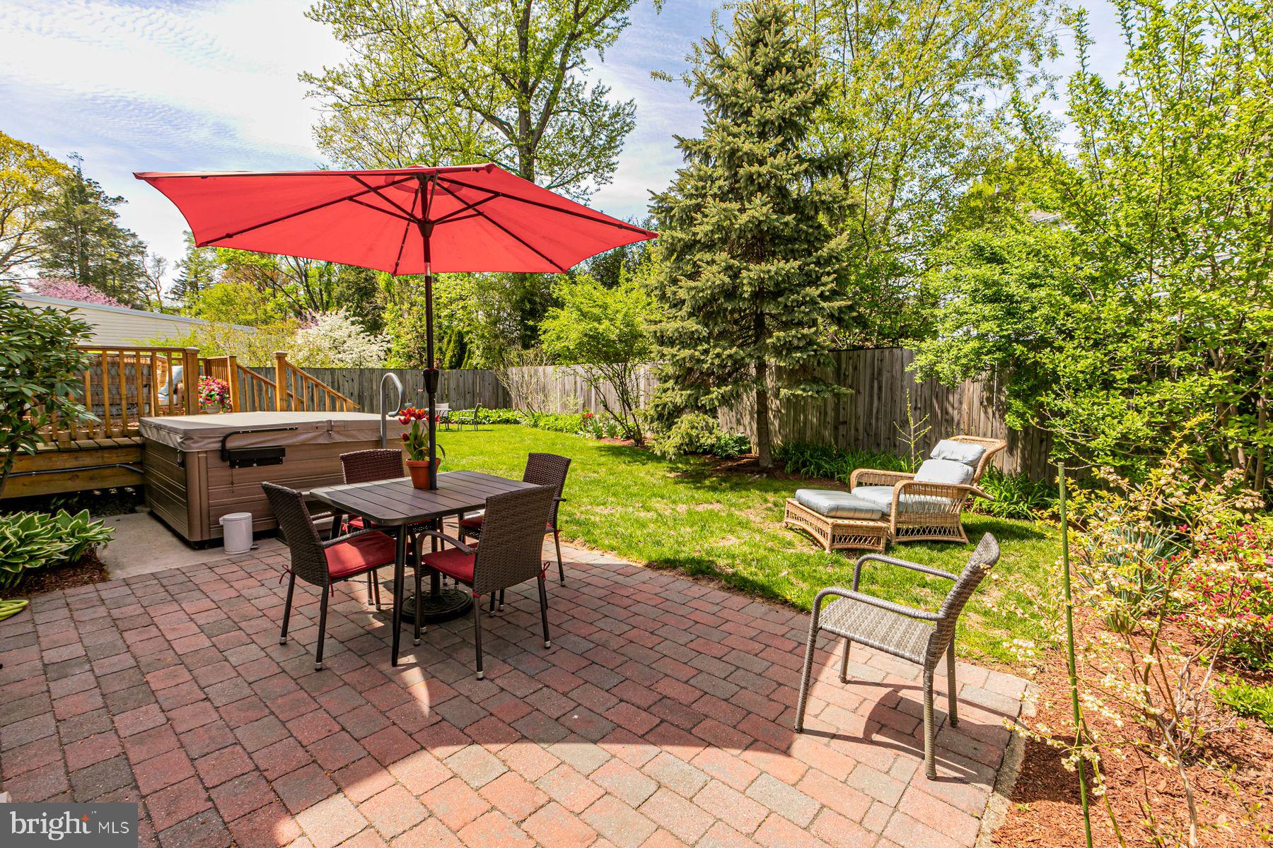 44 Southern Way Princeton, NJ 08540 - Photo 29 of 35 a view of a patio with a dining table and chairs under an umbrella