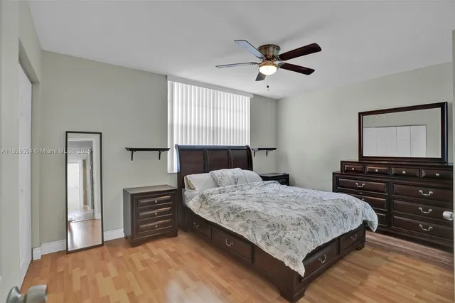 a bedroom with a bed and dresser with mirror