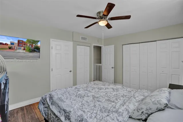 a bedroom that has a bed and a large mirror