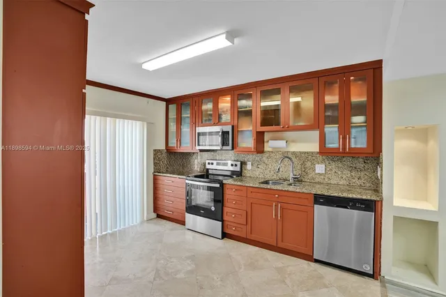 a kitchen with stainless steel appliances granite countertop a stove and a refrigerator