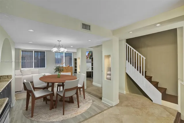 a view of a a dining room with furniture window and wooden floor
