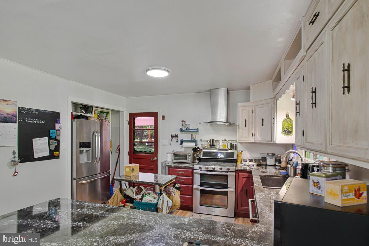 6600 Ashland Road La Plata, MD 20646 - Photo 5 of 40 a kitchen with stainless steel appliances granite countertop a refrigerator stove and sink