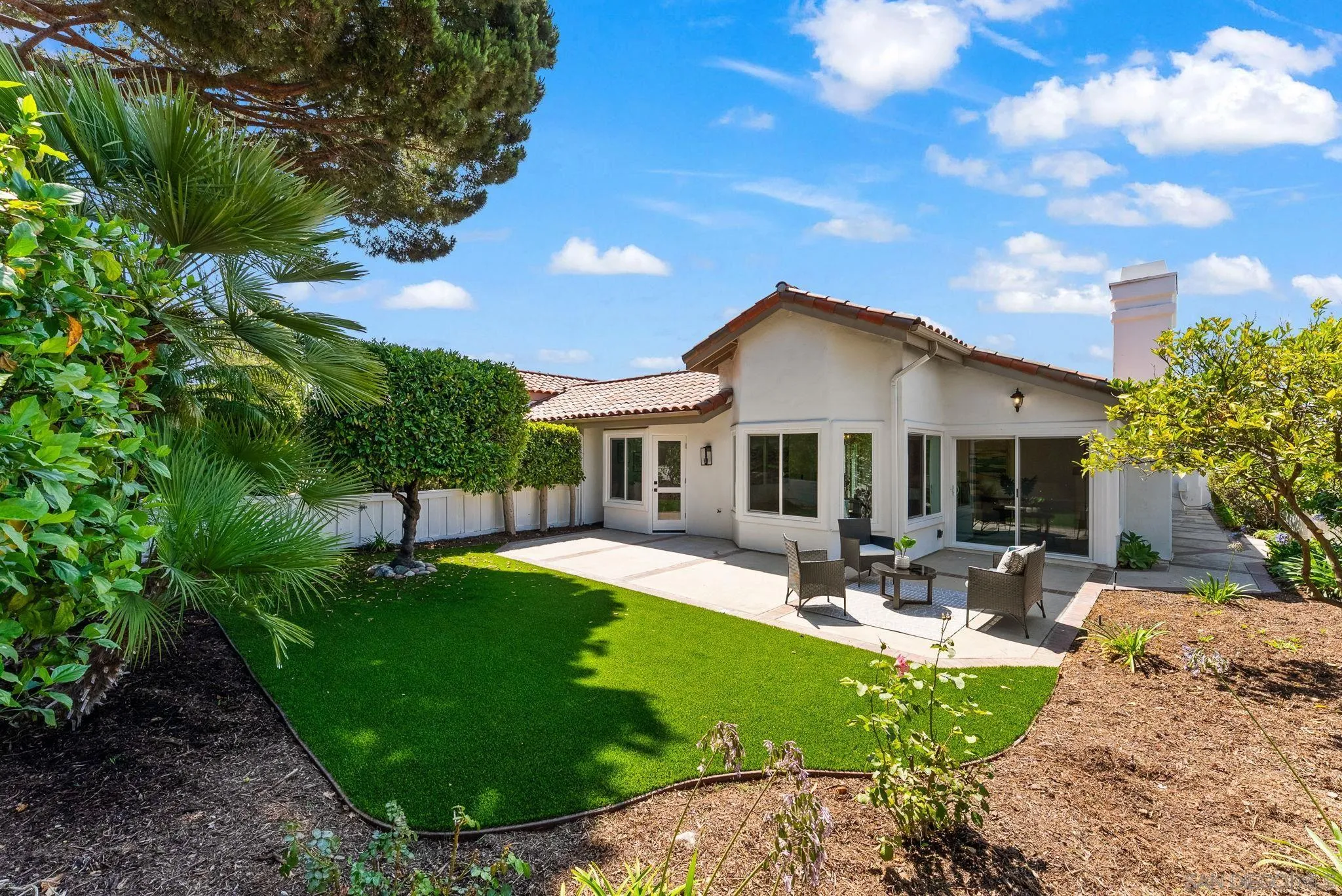a front view of house with yard and outdoor seating
