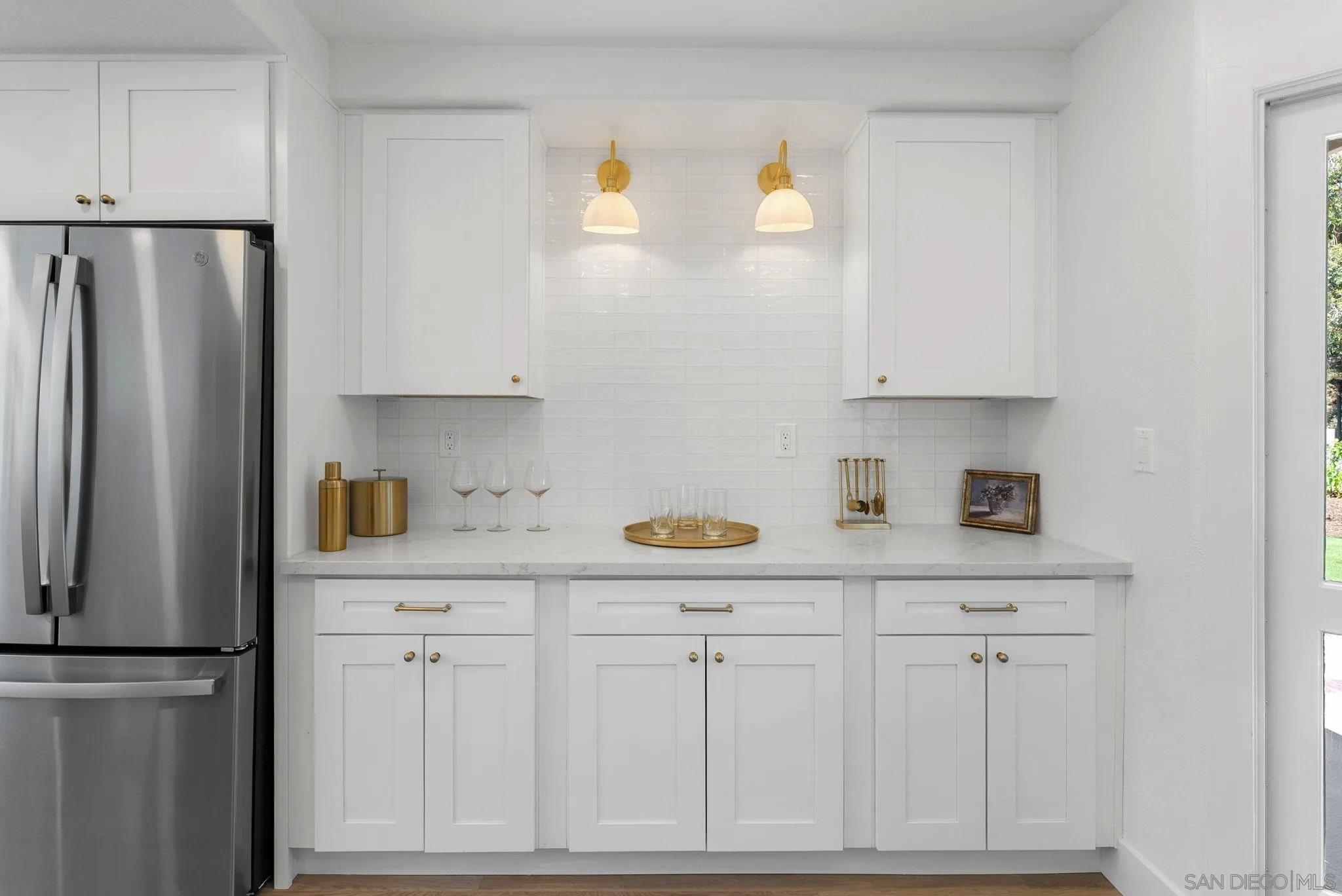 4714 Athos Way Oceanside, CA 92056 - Photo 16 of 34 a kitchen with white cabinets and refrigerator