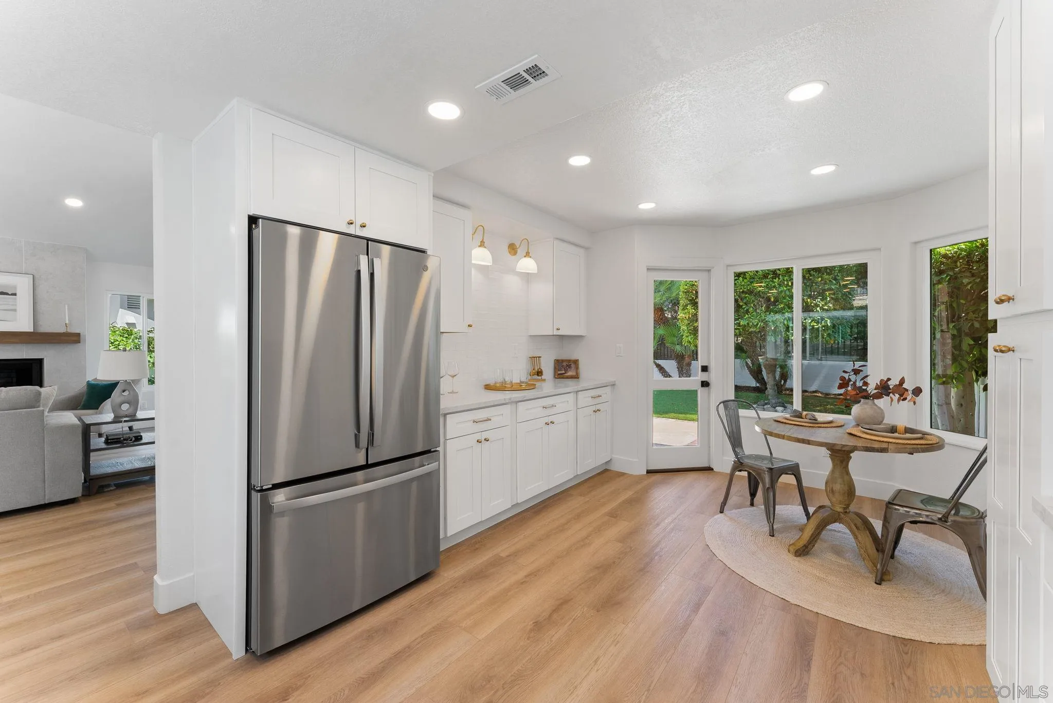 4714 Athos Way Oceanside, CA 92056 - Photo 17 of 34 a kitchen with a refrigerator a table and chairs